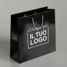 Premium Vertical Shopper in Glossy Black Plasticized Paper with White Custom Print.