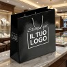Premium Vertical Shopper in Glossy Black Plasticized Paper with White Custom Print.