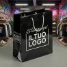 Premium Vertical Shopper in Glossy Black Plasticized Paper with White Custom Print.